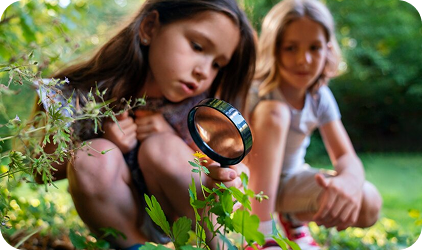 Girl exploring with magnifying glass