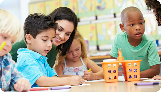 Teacher helping toddlers
